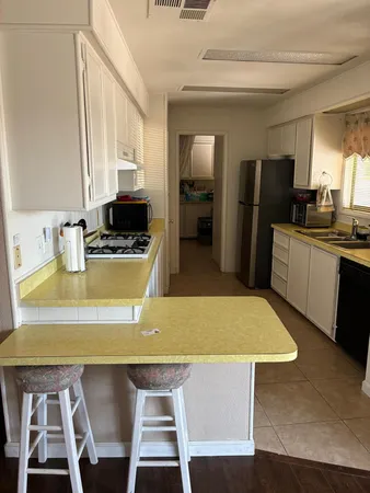 a kitchen with a table chairs and refrigerator