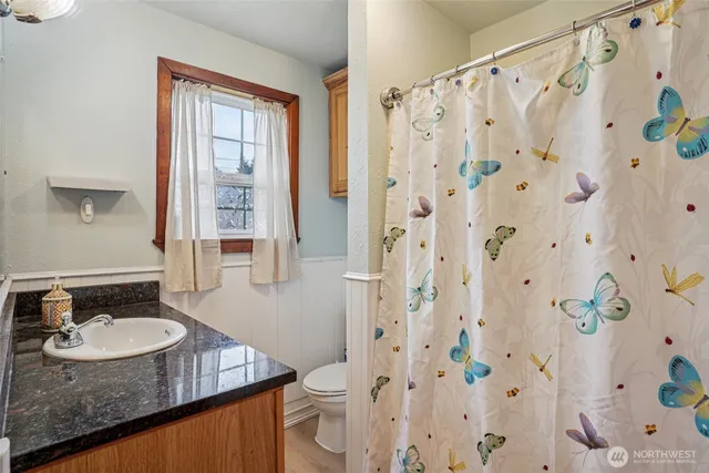 a bathroom with a sink vanity granite and a mirror