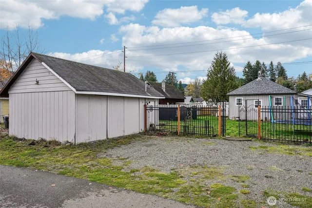 a view of a house with a yard and table in front of it