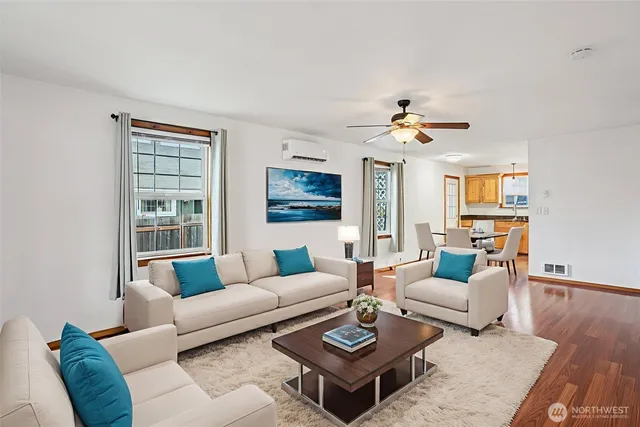 a living room with furniture a chandelier and a table