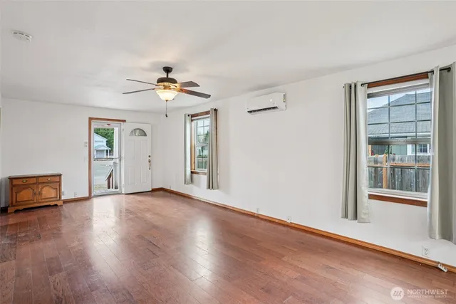 wooden floor in an empty room with a window