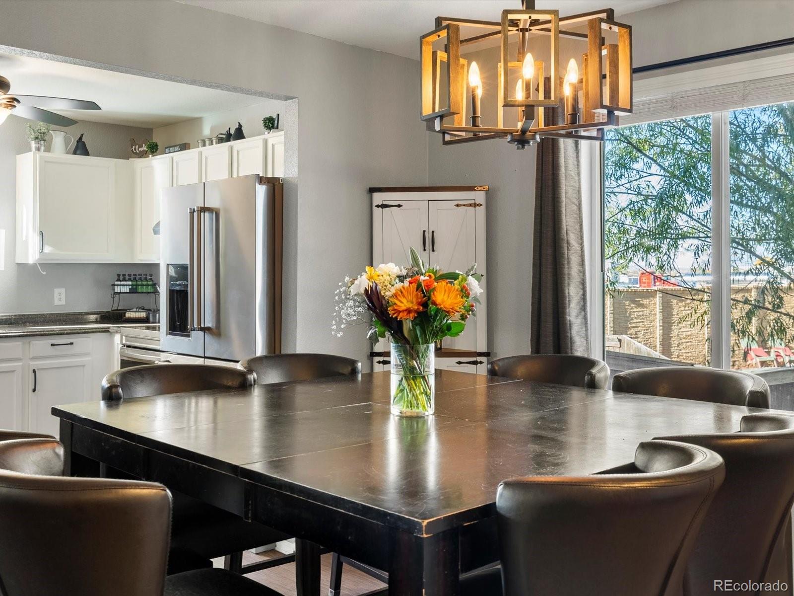 9657 Ironton Street Commerce City, CO 80022 - Photo 11 of 48 a dining room with furniture and window