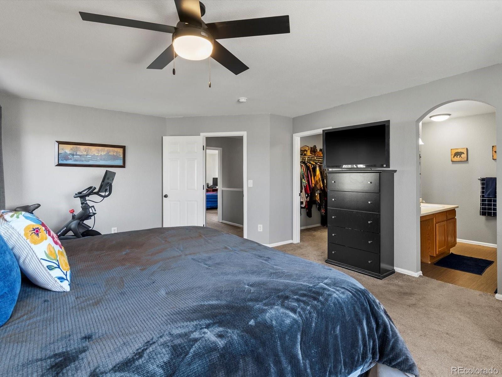 9657 Ironton Street Commerce City, CO 80022 - Photo 25 of 48 a bedroom with bed and a chandelier