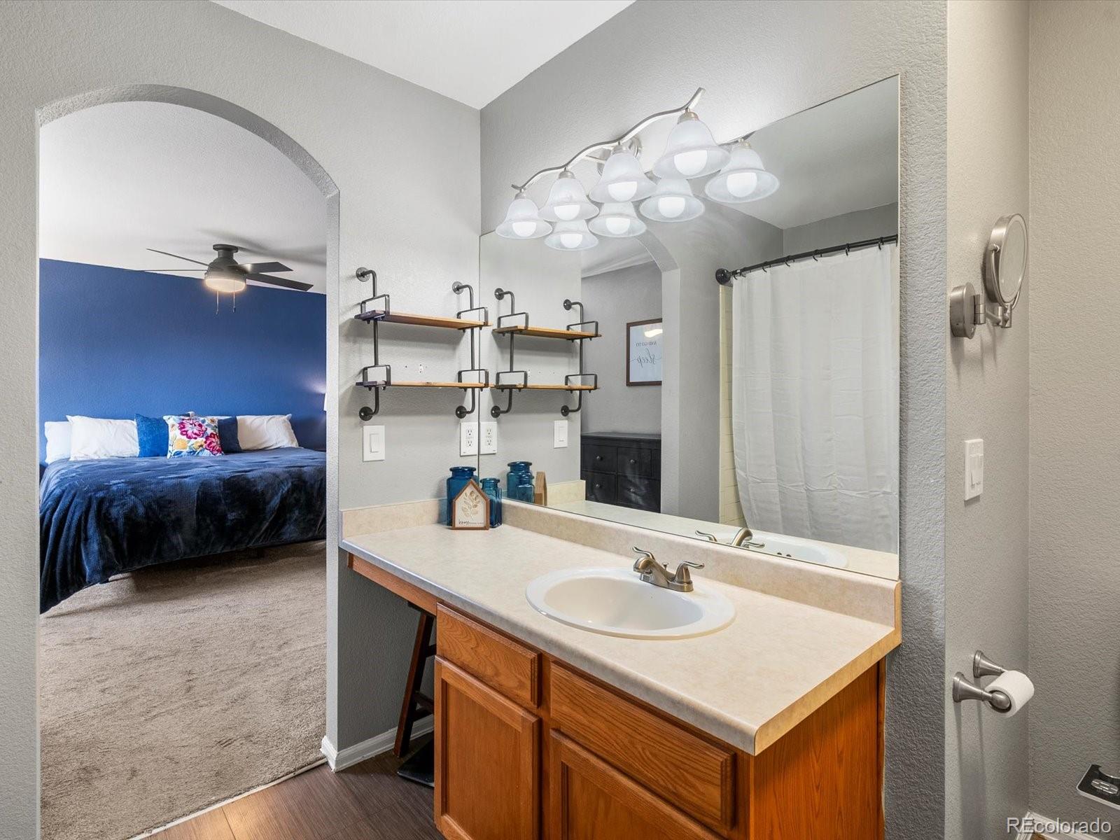 9657 Ironton Street Commerce City, CO 80022 - Photo 27 of 48 a en suite bathroom with a sink double vanity and a mirror