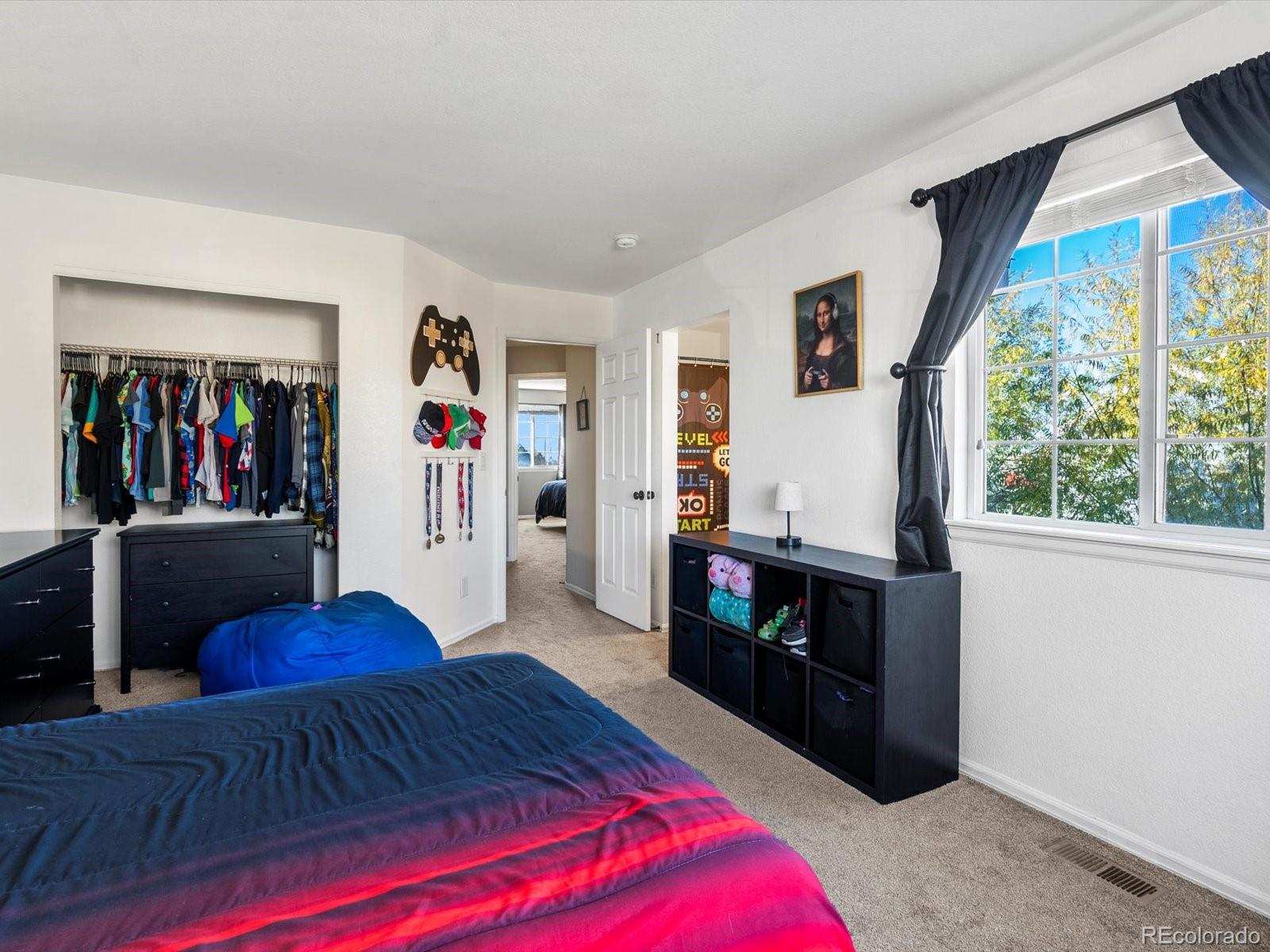 9657 Ironton Street Commerce City, CO 80022 - Photo 30 of 48 a living room with stainless steel appliances furniture a rug and a large window