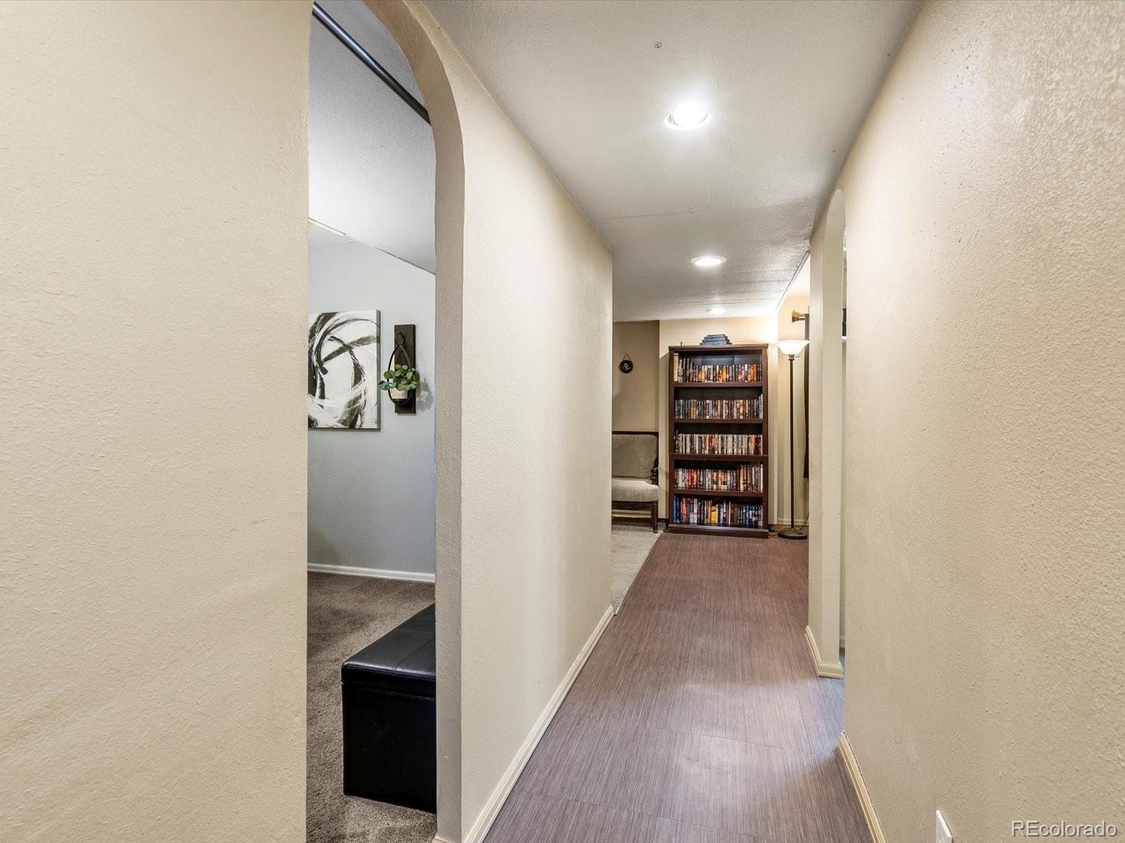 9657 Ironton Street Commerce City, CO 80022 - Photo 32 of 48 a view of a hallway with wooden shelves