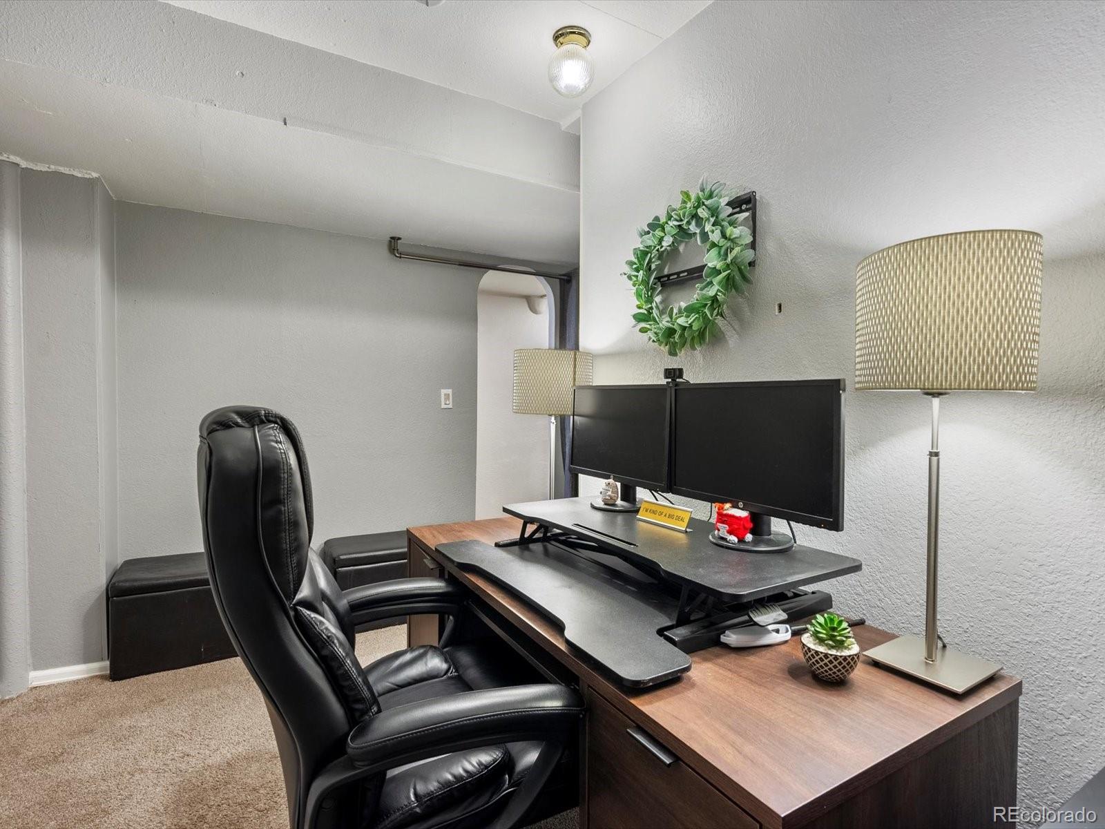 9657 Ironton Street Commerce City, CO 80022 - Photo 34 of 48 a living room with furniture and a potted plant
