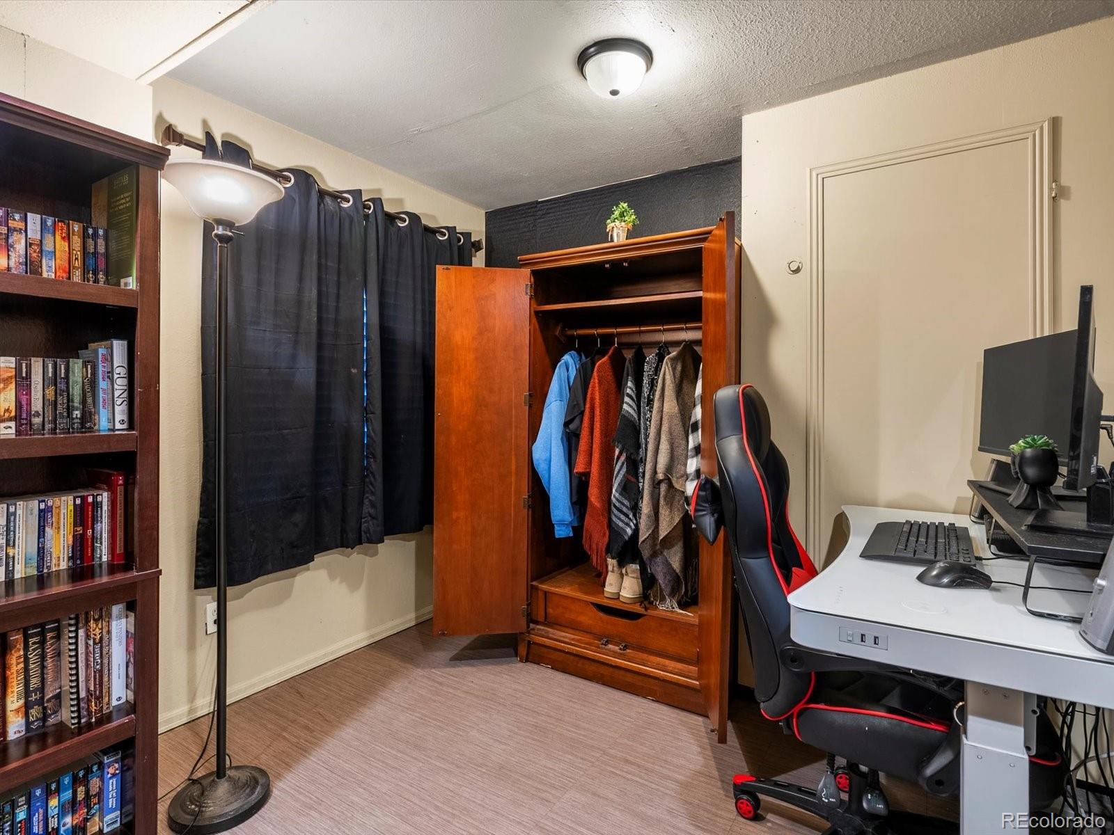 9657 Ironton Street Commerce City, CO 80022 - Photo 41 of 48 a view of walk in closet with clothes and shoes