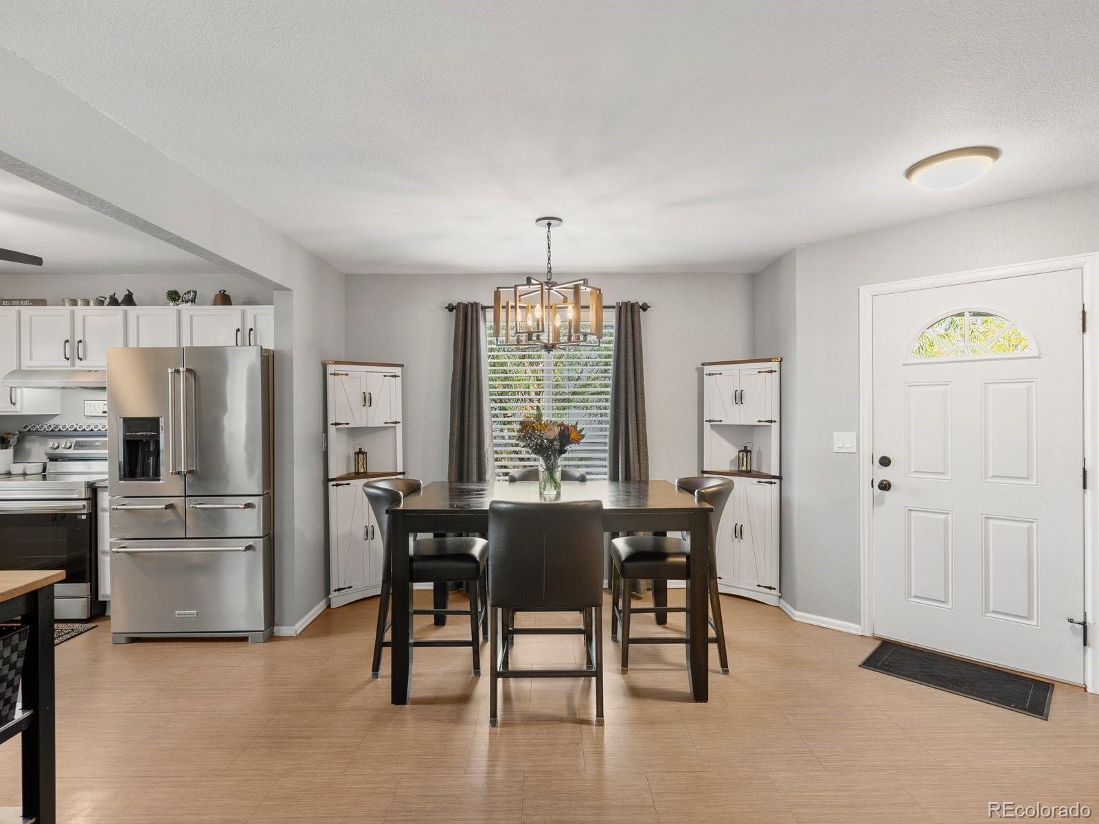 9657 Ironton Street Commerce City, CO 80022 - Photo 7 of 48 a view of a dining room with furniture window and outside view