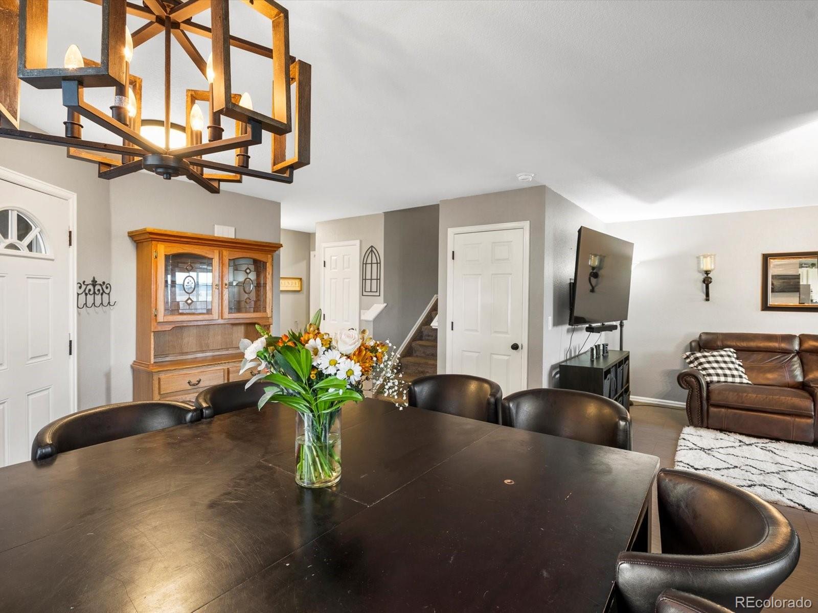 9657 Ironton Street Commerce City, CO 80022 - Photo 10 of 48 a living room with furniture flowerpot and a rug