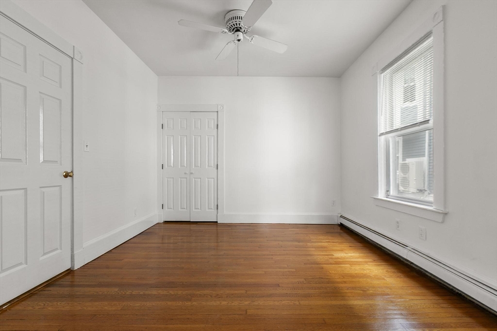27 Dix Street, Unit 1 Boston, MA 02122 - Photo 5 of 10 wooden floor in an empty room with a window