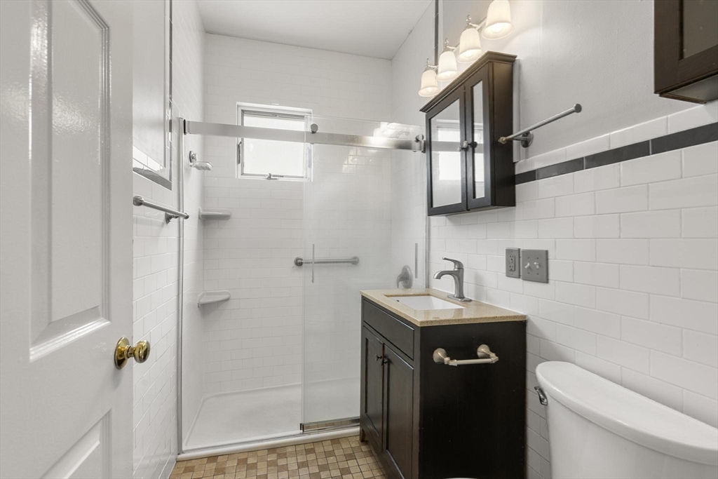 27 Dix Street, Unit 1 Boston, MA 02122 - Photo 7 of 10 a bathroom with a sink a toilet and shower