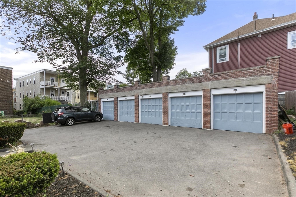 27 Dix Street, Unit 1 Boston, MA 02122 - Photo 9 of 10 a view of a house with a yard and garage