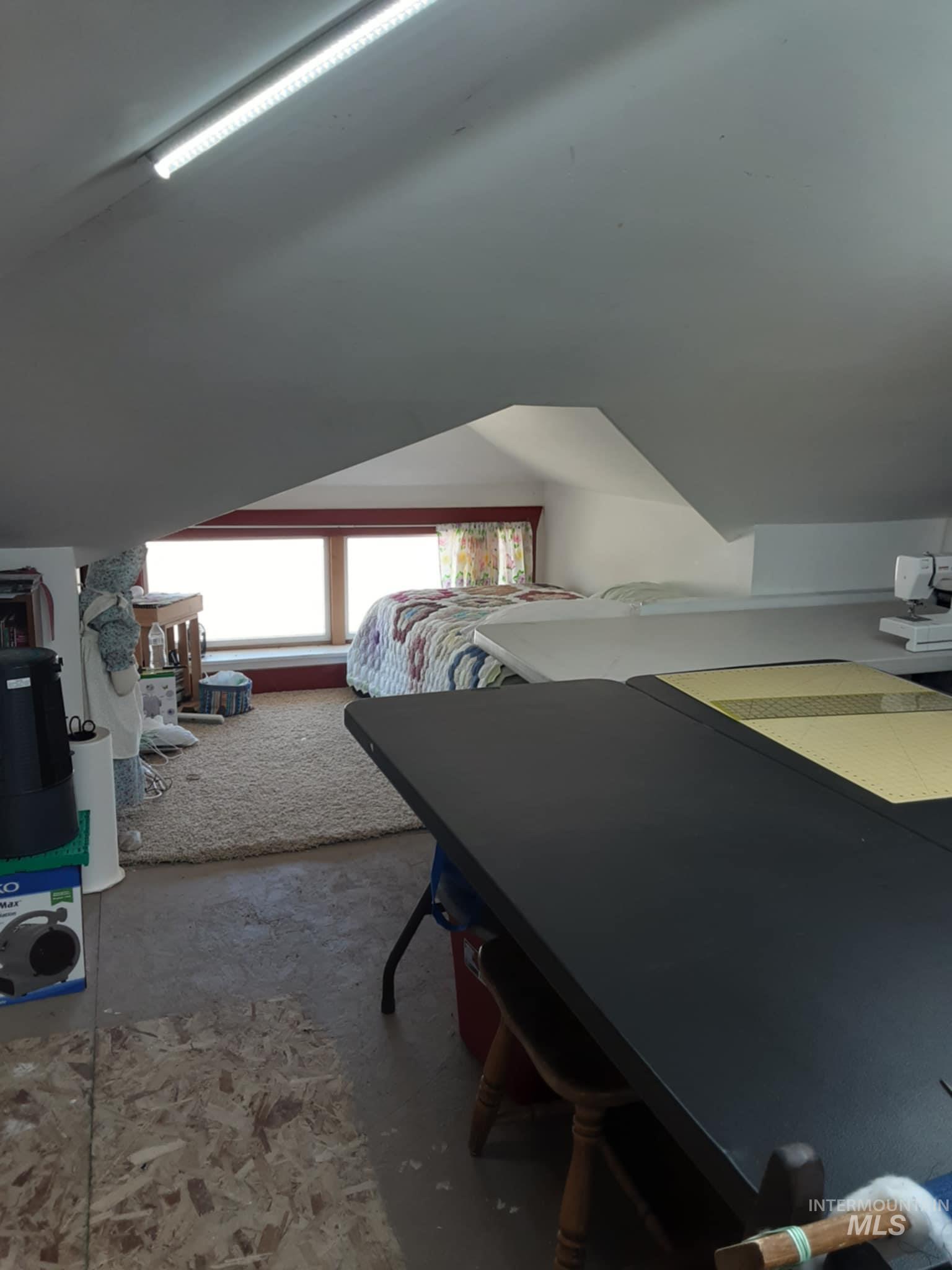 145 North Lincoln Avenue Oakley, ID 83346 - Photo 31 of 48 Bedroom featuring lofted ceiling and unfinished concrete floors