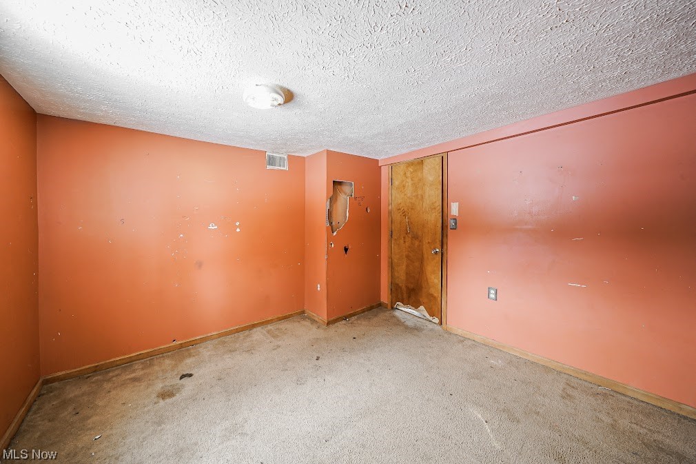9606 Durst Colebrook Road North Bloomfield, OH 44450 - Photo 15 of 24 Spare room with a textured ceiling and light colored carpet