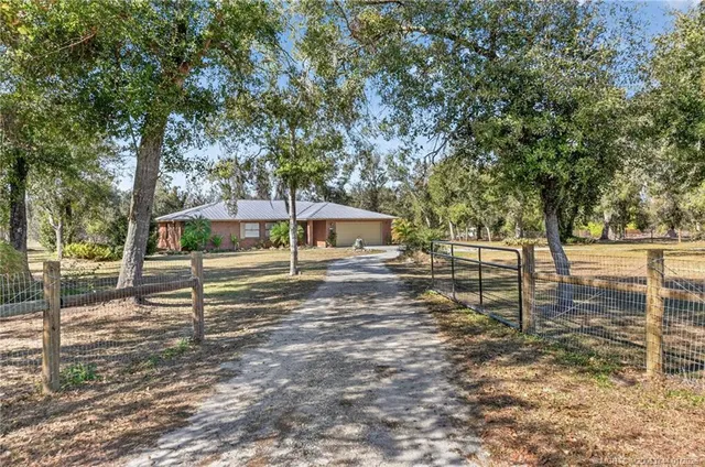 a view of a yard with wooden fence
