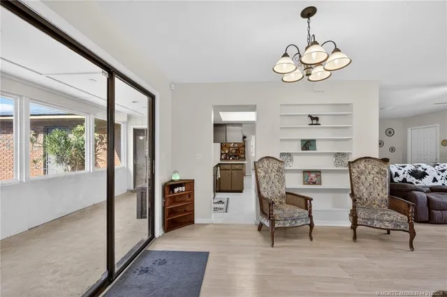 a view of a kitchen with refrigerator and window