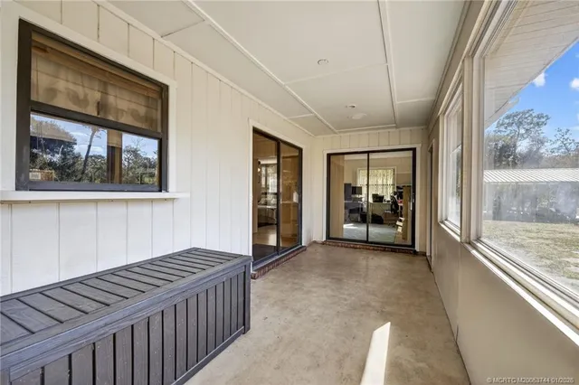 a view of a backyard with table and chairs under an umbrella