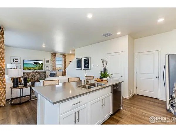 a kitchen with sink and refrigerator