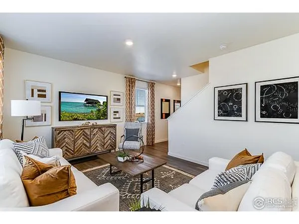 a living room with furniture and painting on the wall