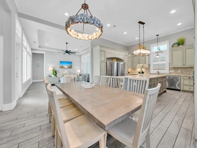 a view of a patio with couches table and chairs and potted plants