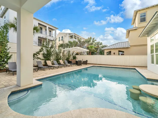 a room with pool table and windows