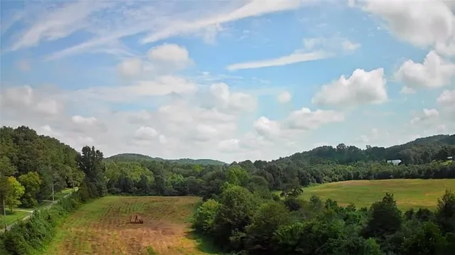 a view of a lake and green valley