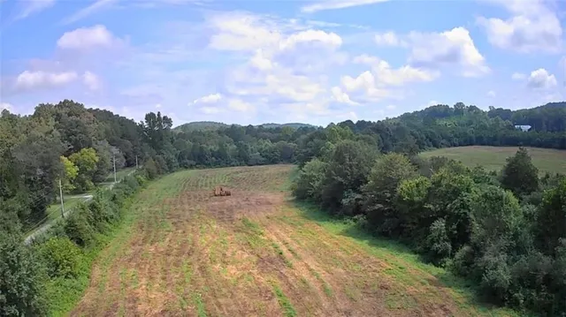 a view of a field with trees in background