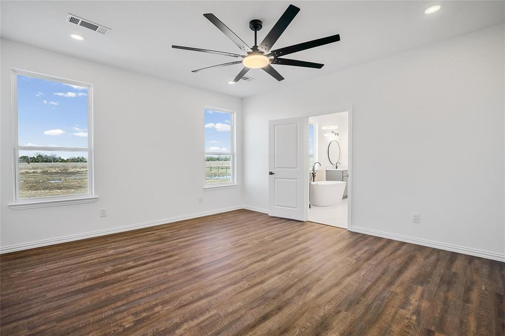 3093 Willow Road Celeste, TX 75423 - Photo 28 of 40 an empty room with wooden floor and windows