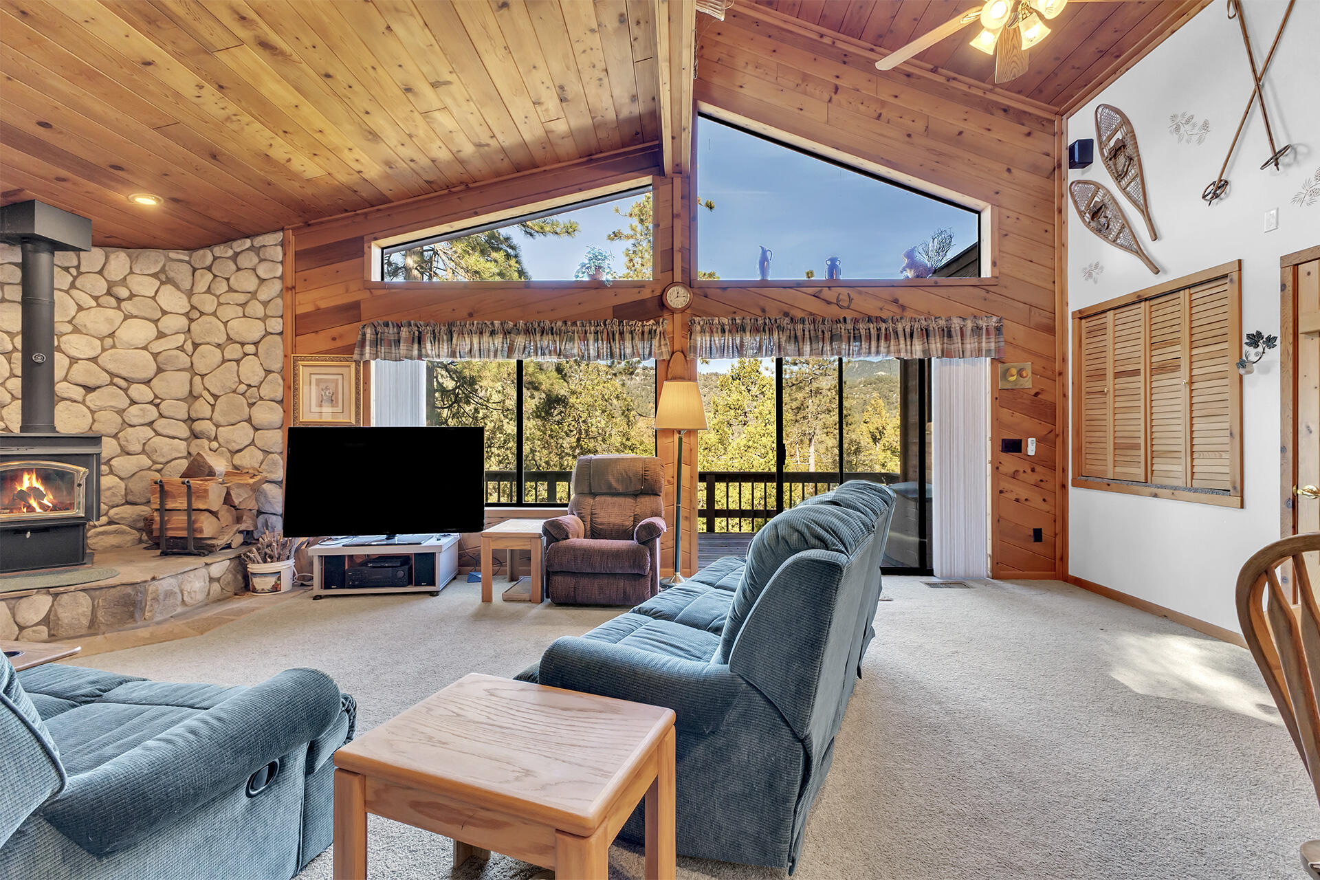 53071 Middleridge Drive Idyllwild, CA 92549 - Photo 14 of 50 a living room with furniture a flat screen tv and large windows