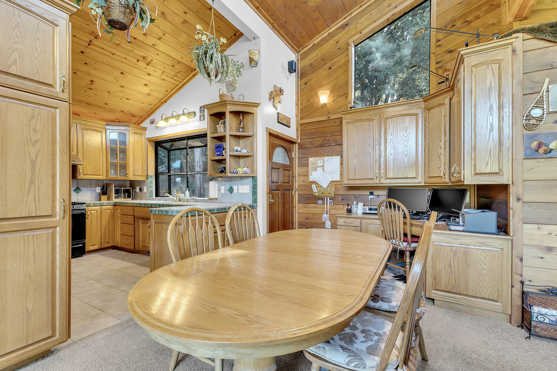 53071 Middleridge Drive Idyllwild, CA 92549 - Photo 15 of 50 a kitchen with refrigerator a stove and white cabinets