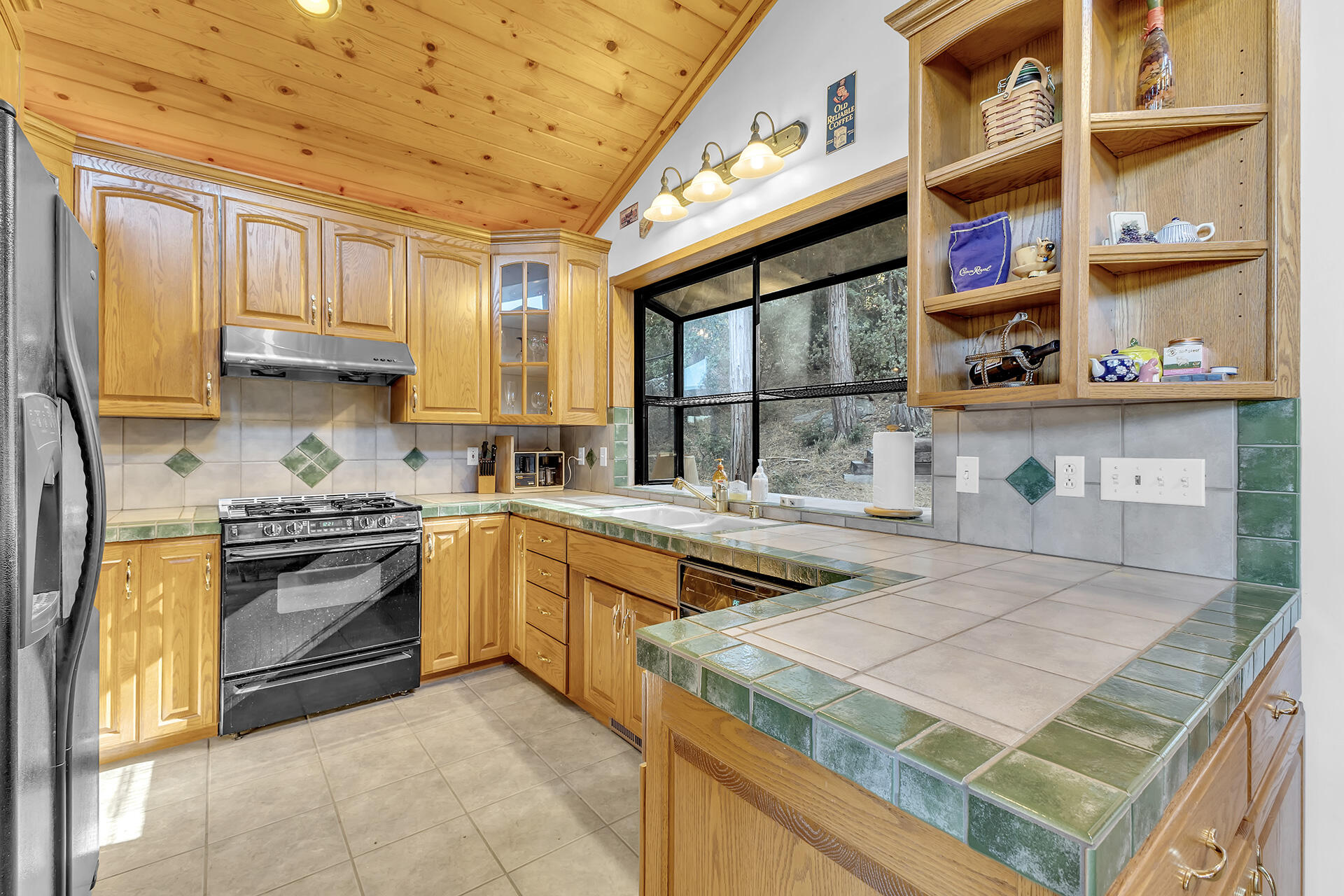 53071 Middleridge Drive Idyllwild, CA 92549 - Photo 17 of 50 a kitchen with stainless steel appliances granite countertop a stove and a sink