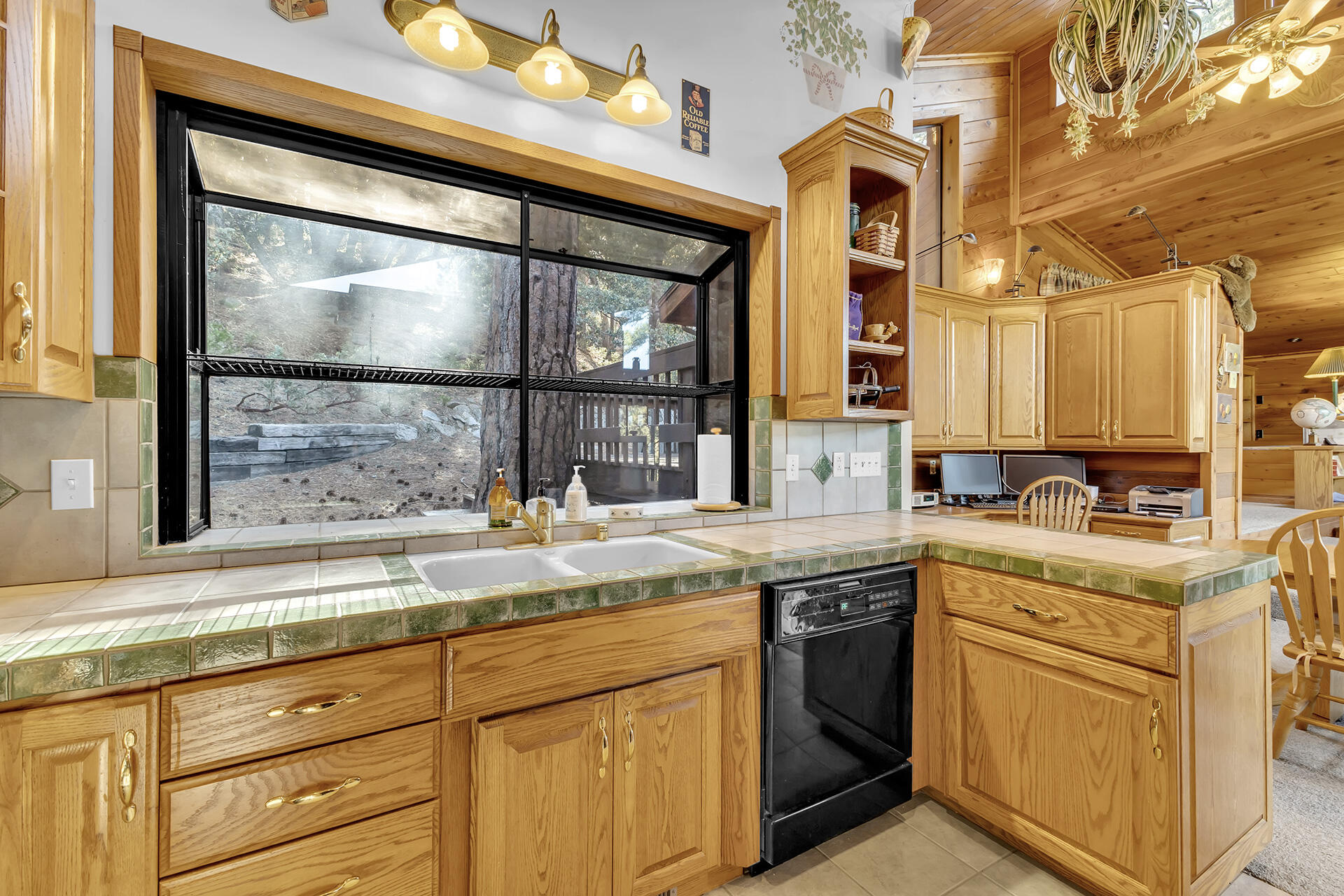 53071 Middleridge Drive Idyllwild, CA 92549 - Photo 19 of 50 a kitchen with granite countertop a sink and a stove next to a window