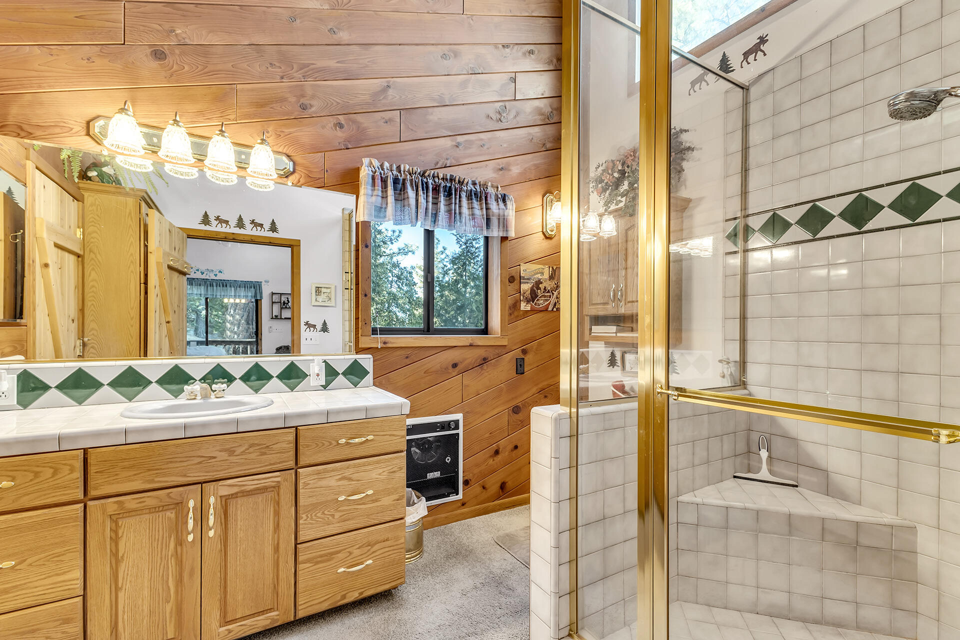 53071 Middleridge Drive Idyllwild, CA 92549 - Photo 26 of 50 a bathroom with a sink and mirror with shower