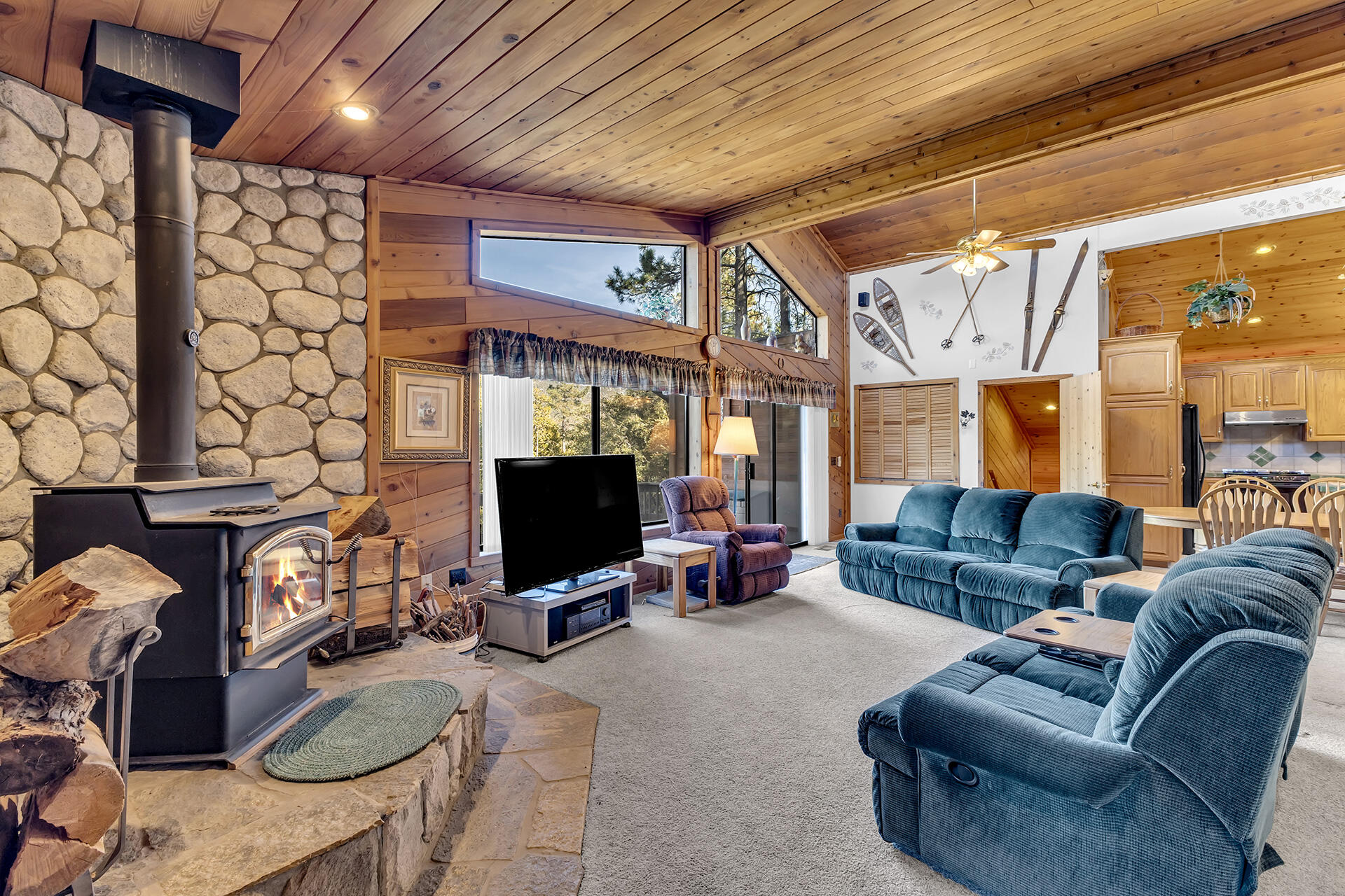 53071 Middleridge Drive Idyllwild, CA 92549 - Photo 9 of 50 a living room with furniture a flat screen tv and a table