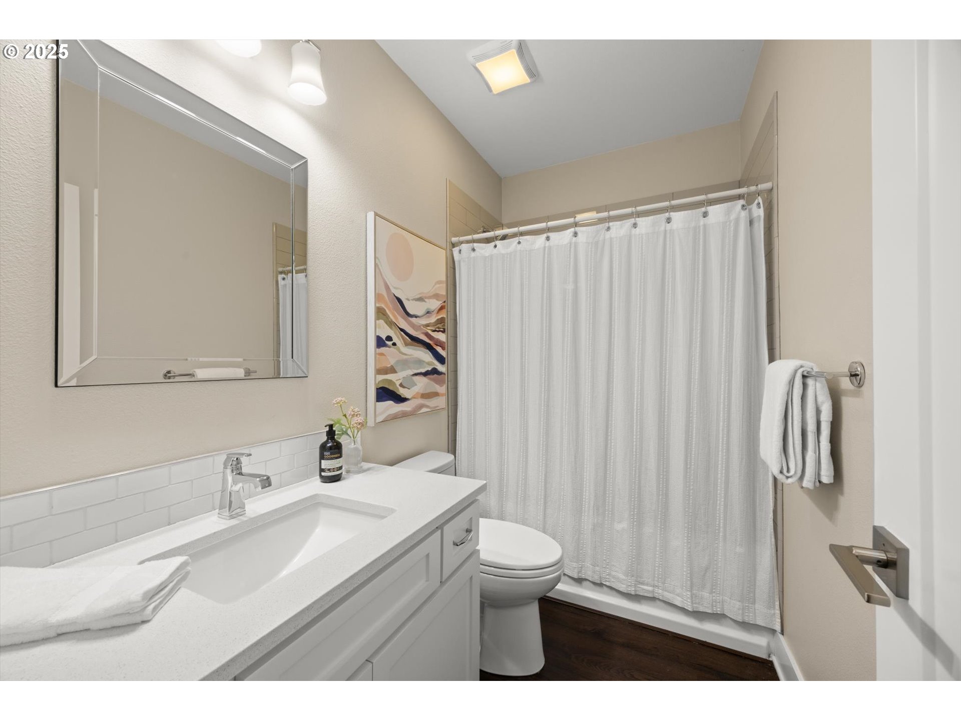 8623 Southeast 11th Avenue Portland, OR 97202 - Photo 19 of 46 a bathroom with a sink a toilet and a mirror