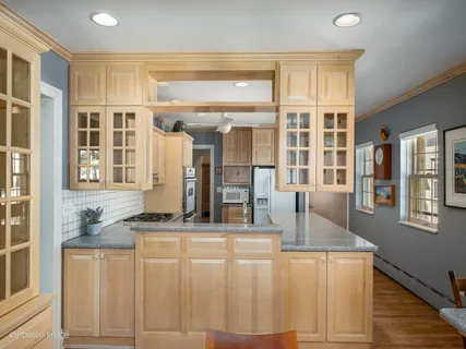 a kitchen with stainless steel appliances granite countertop a refrigerator and cabinets