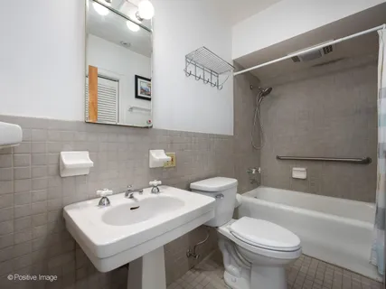 a bathroom with a sink toilet and a bathtub
