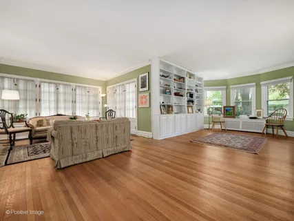 a living room with furniture and hard wood flooring
