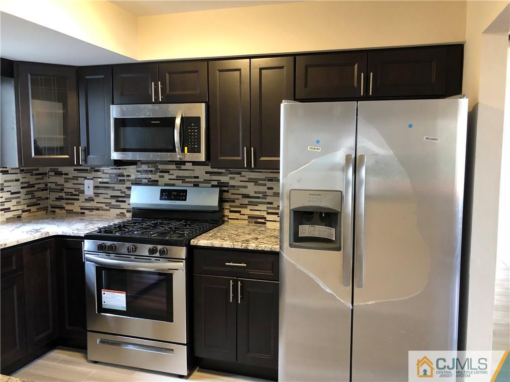 16 Shelly Road Old Bridge, NJ 08857 - Photo 2 of 25 a kitchen with a refrigerator stove and microwave