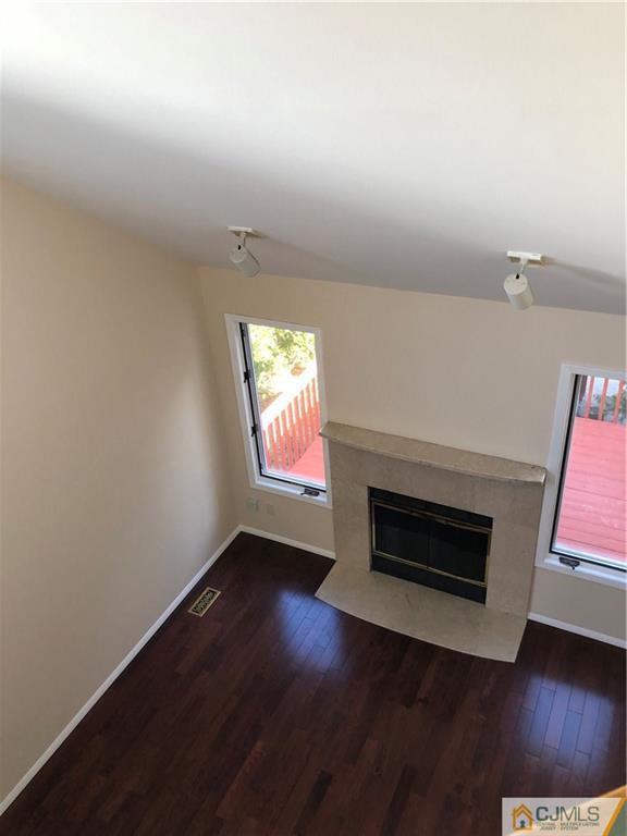 16 Shelly Road Old Bridge, NJ 08857 - Photo 11 of 25 an empty room with wooden floor fire place and windows