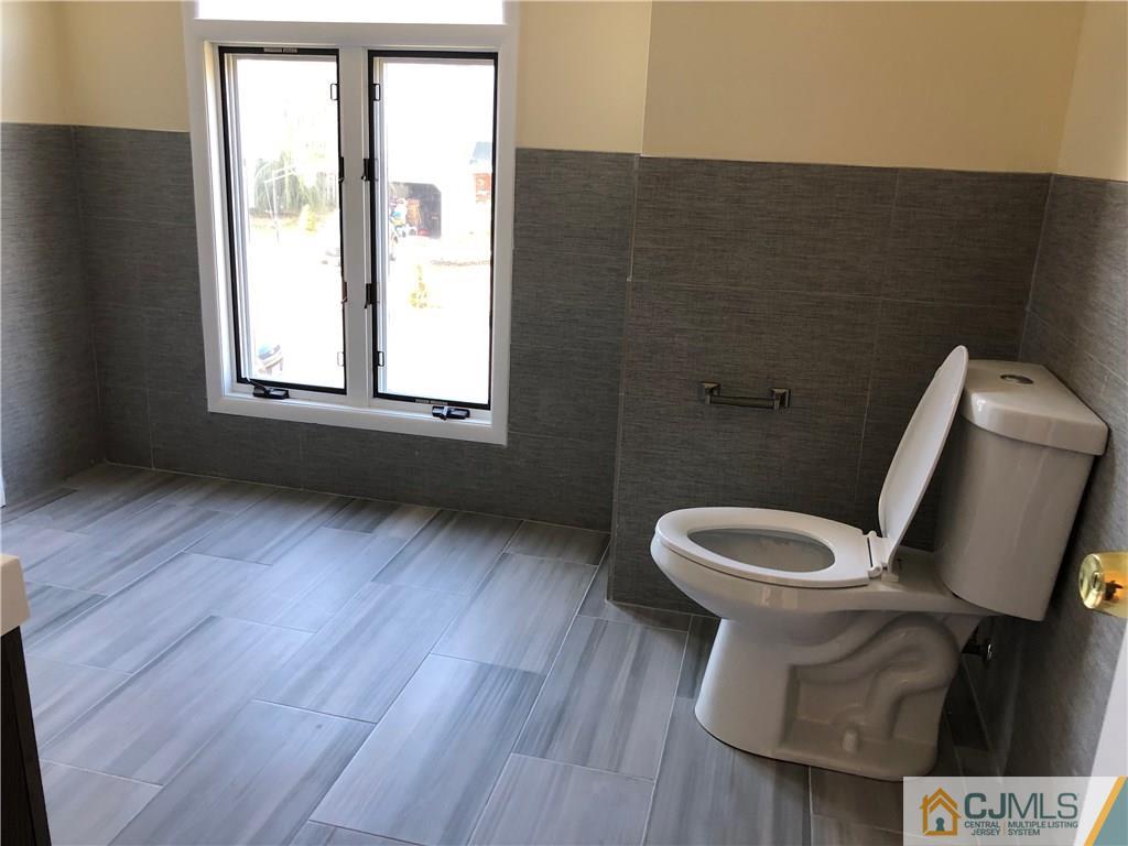 16 Shelly Road Old Bridge, NJ 08857 - Photo 18 of 25 a bathroom with a toilet sink and mirror