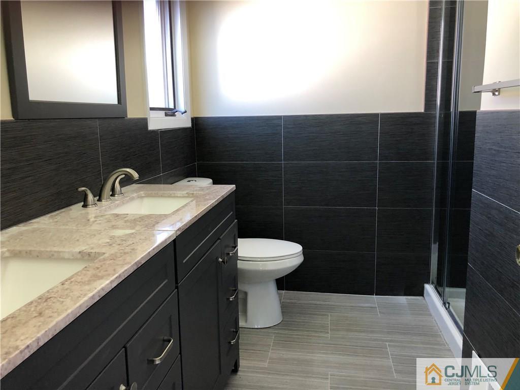 16 Shelly Road Old Bridge, NJ 08857 - Photo 20 of 25 a bathroom with a granite countertop sink toilet a mirror and a shower