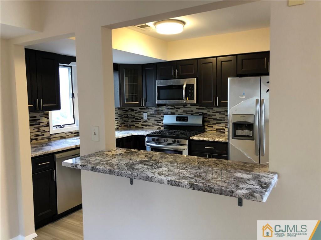 16 Shelly Road Old Bridge, NJ 08857 - Photo 3 of 25 a kitchen with stainless steel appliances granite countertop a refrigerator stove and microwave