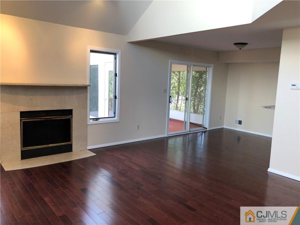 16 Shelly Road Old Bridge, NJ 08857 - Photo 4 of 25 an empty room with wooden floor and fireplace