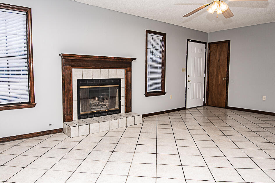 116 Walker Circle West Crestview, FL 32539 - Photo 4 of 20 a view of an empty room with window and fireplace