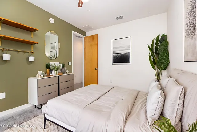 a bedroom with a bed and a dresser