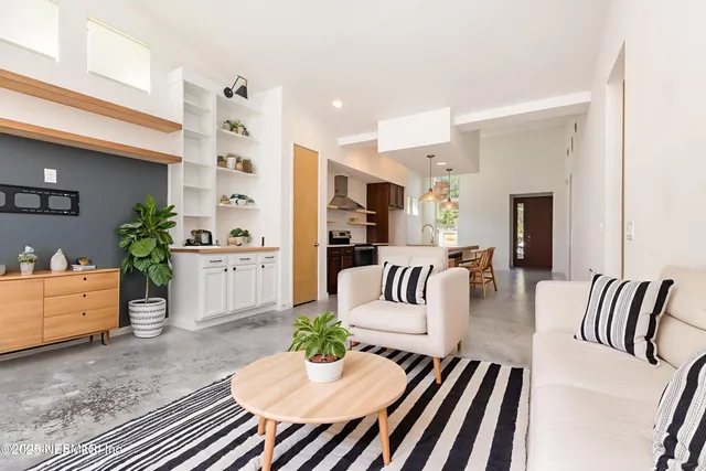 a living room with furniture fireplace and window