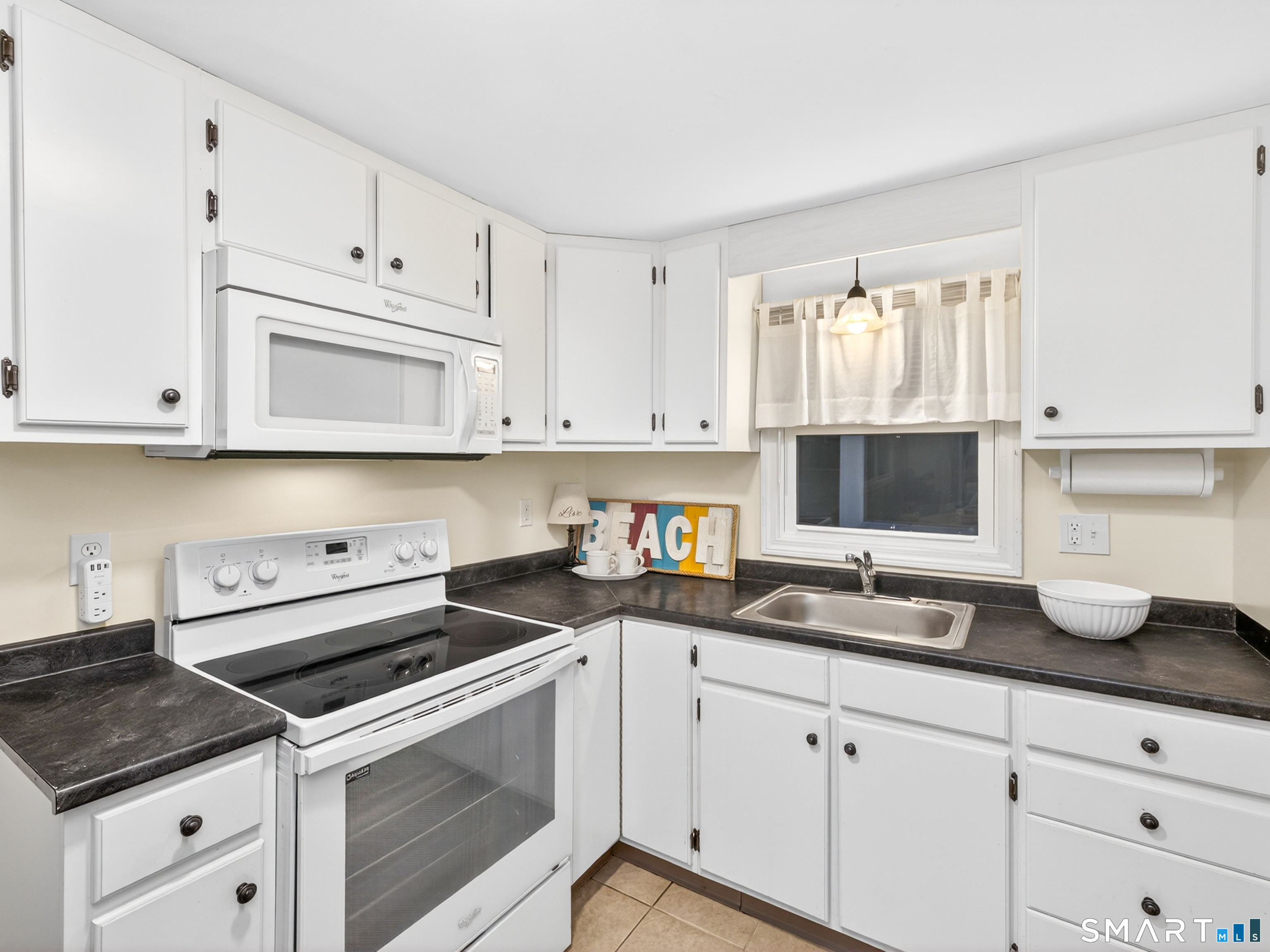 31 Old Colony Road Old Lyme, CT 06371 - Photo 32 of 38 a kitchen with granite countertop white cabinets and white appliances