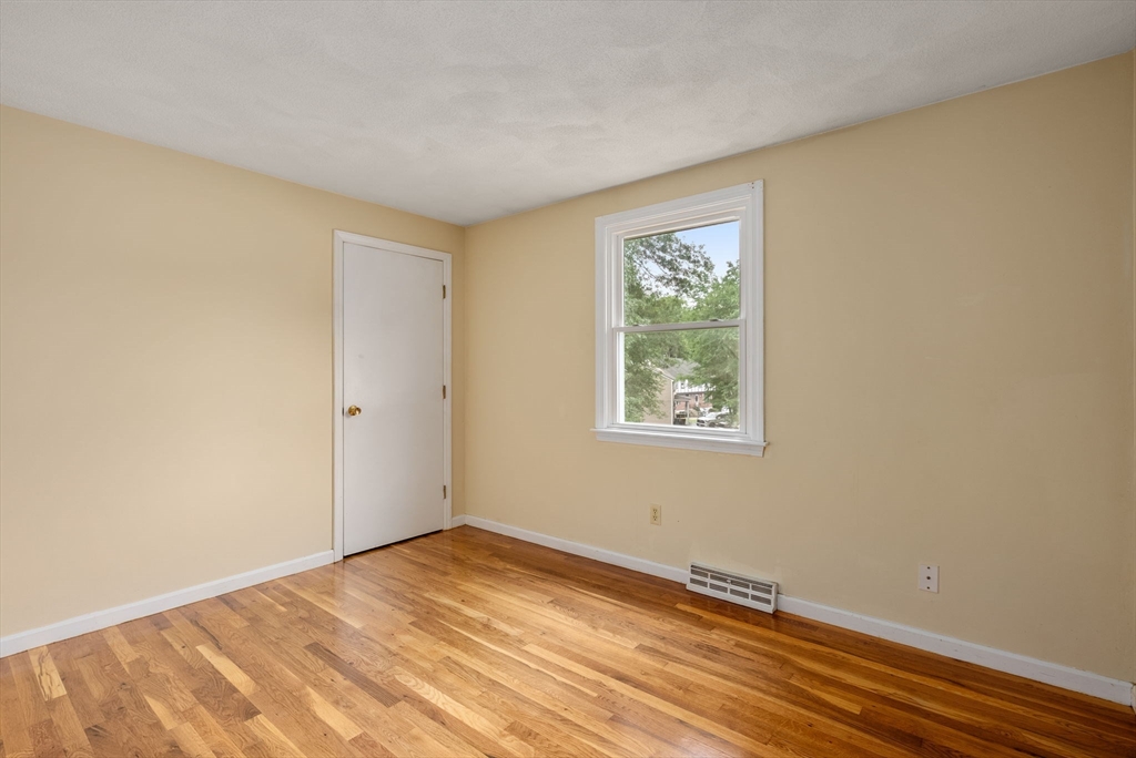 5 Old Central Turnpike Framingham, MA 01702 - Photo 14 of 32 an empty room with wooden floor and windows